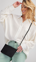 	Kai Buttondown, long sleeve, collared neckline with a button down front. 