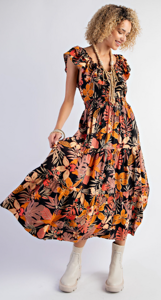 	Kauai Dress is a blossom print tiered maxi dress with a rounded neckline and adjustable back tie with a ruffled shoulder. 