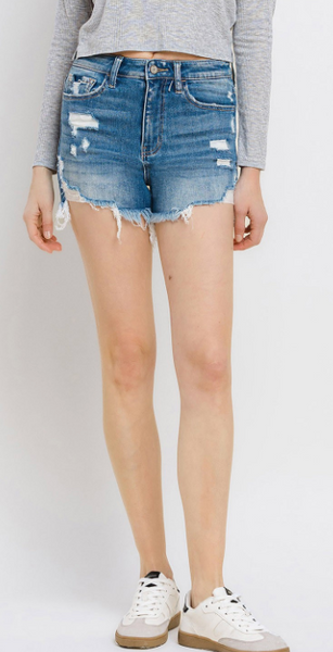 	The Super Hi Rise shorts made with comfort stretch denim feature distressed detailing and a frayed hem. 